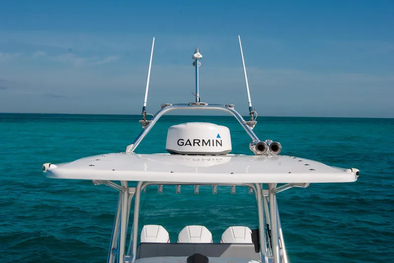  Yacht Photos Pics Boat with Garmin radar system on turquoise ocean, clear sky background.