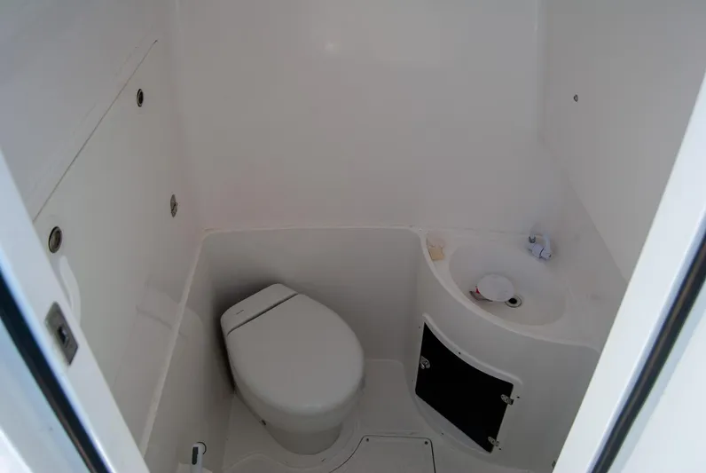  Yacht Photos Pics Compact white boat bathroom with toilet and small sink, IMG 40 model, 2021.