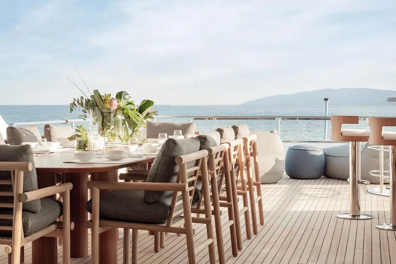  Yacht Photos Pics Luxurious deck of 2024 Azimut Magellano 30M yacht with elegant dining setup and ocean view.