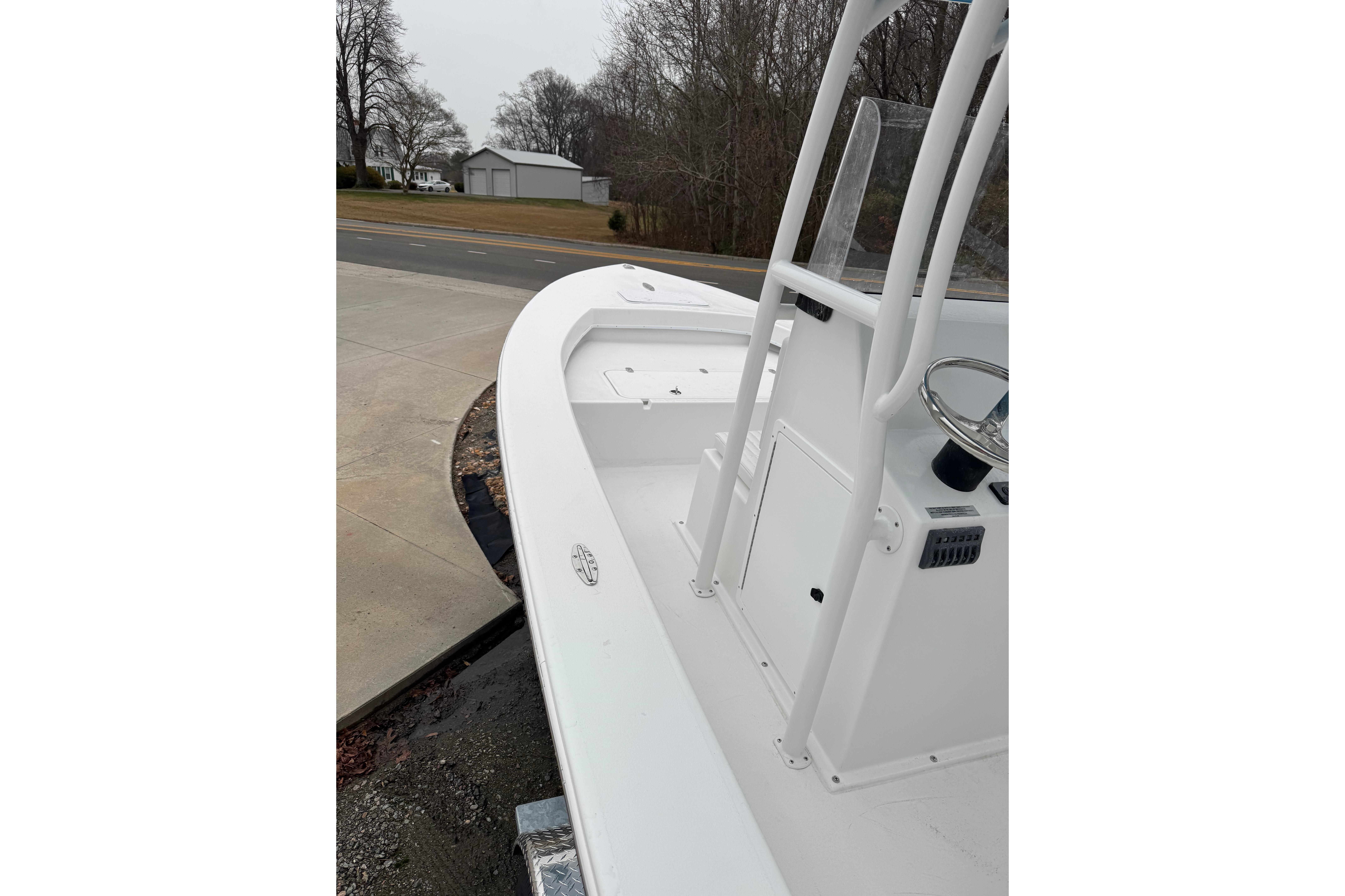 2026 C-Hawk 23 Center Console boat with sleek white design on a trailer.