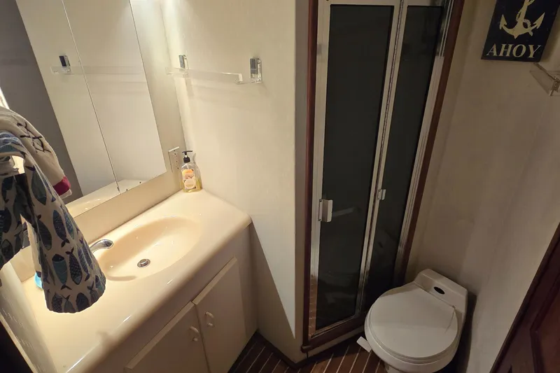  Yacht Photos Pics Bathroom interior of 1990 Viking 43 Convertible yacht with sink, shower, and toilet.