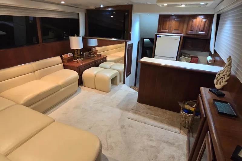  Yacht Photos Pics Luxurious interior of a 1990 Viking 43 Convertible yacht with beige seating and wooden accents.