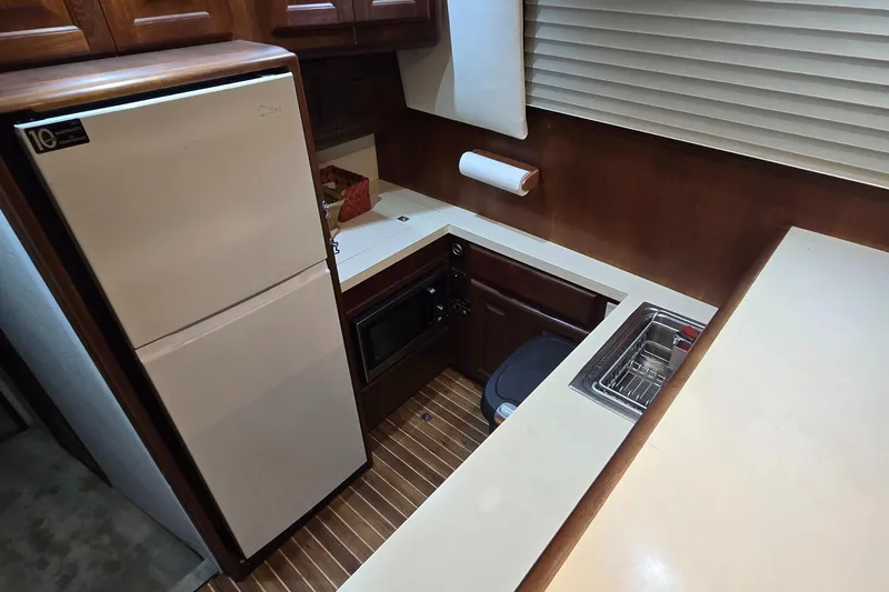  Yacht Photos Pics 1990 Viking 43 Convertible yacht kitchen with fridge, microwave, and sink.