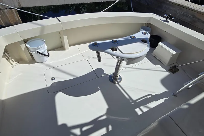  Yacht Photos Pics 1990 Viking 43 Convertible boat deck with fishing rod holders and seating area.