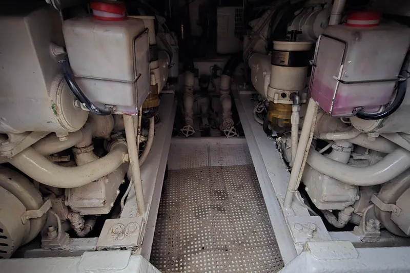  Yacht Photos Pics Engine room of a 1990 Viking 43 Convertible boat, showcasing dual engines.