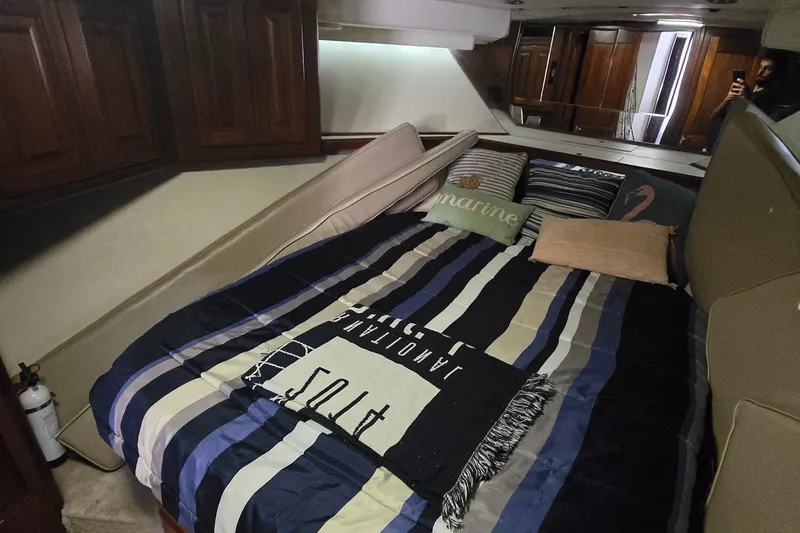  Yacht Photos Pics Cozy bedroom in 1990 Viking 43 Convertible yacht with striped bedding and pillows.