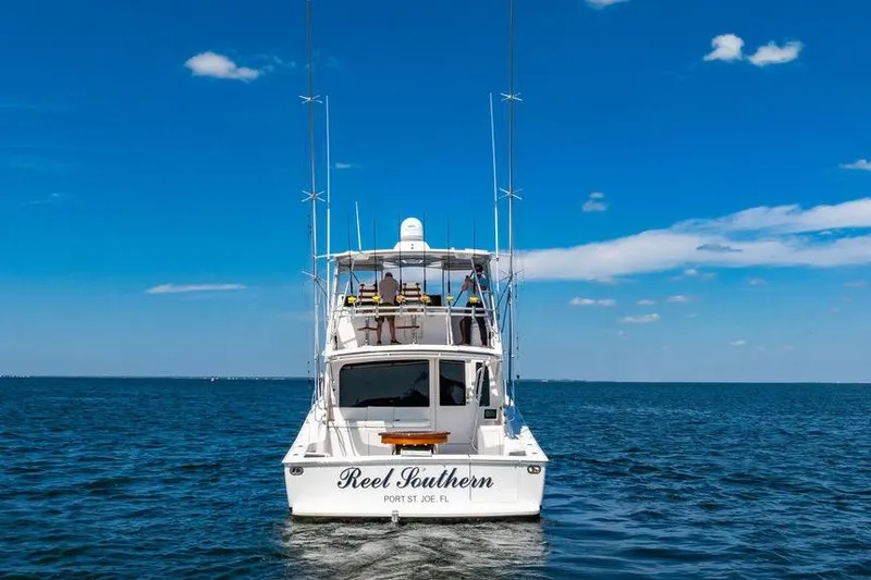 Reel Southern Yacht Photos Pics 2006 Viking 56 Convertible boat on open water under clear blue sky.
