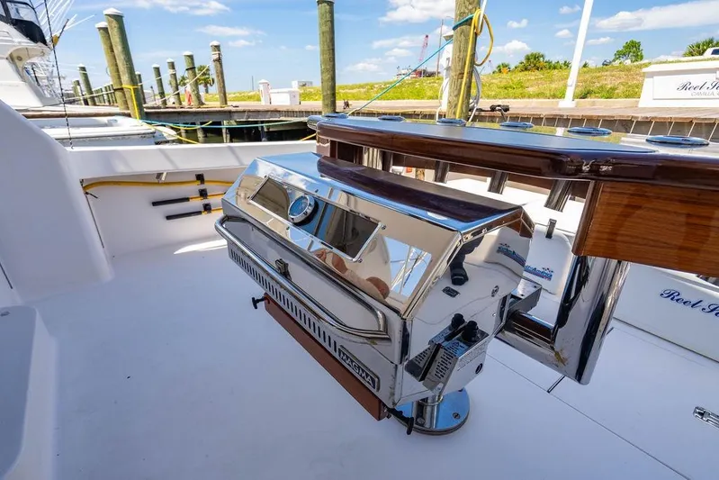 Reel Southern Yacht Photos Pics Luxury grill setup on 2006 Viking 56 Convertible yacht deck, docked at marina.