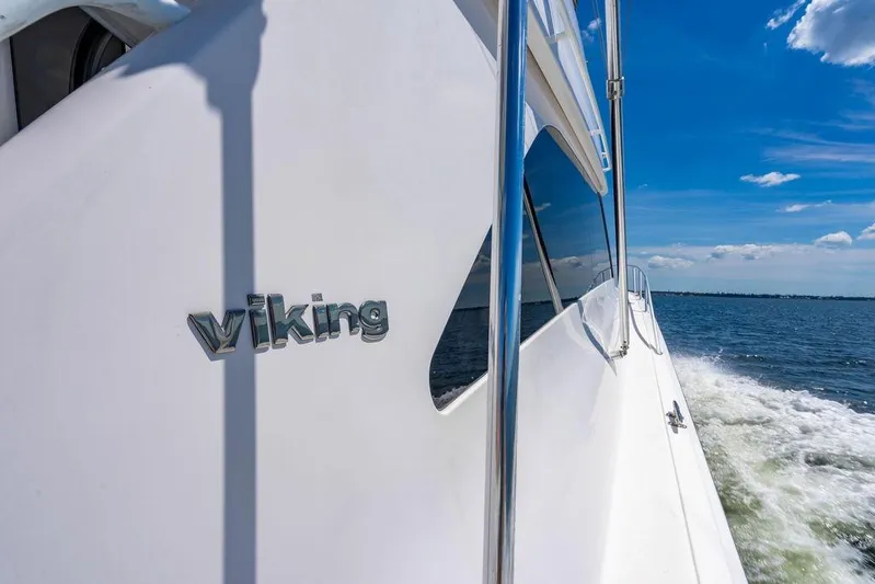 Reel Southern Yacht Photos Pics 2006 Viking 56 Convertible yacht cruising on open water under blue sky.