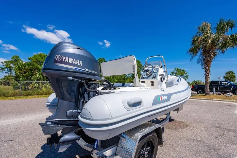 Reel Southern Yacht Photos Pics A Yamaha-powered AB inflatable boat on a trailer under a clear blue sky.