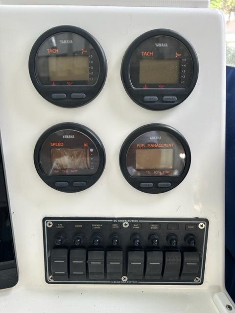 Yamaha gauges and switches on a 2000 Regulator 23' Center Console boat dashboard.