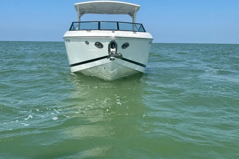  Yacht Photos Pics 2019 Cobalt R30 boat on calm green sea under clear blue sky.
