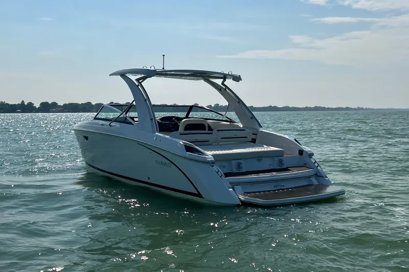  Yacht Photos Pics 2019 Cobalt R30 boat on calm water under a clear sky.