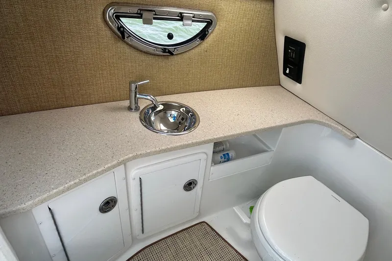  Yacht Photos Pics 2019 Cobalt R30 boat bathroom with sink, toilet, and storage cabinets.