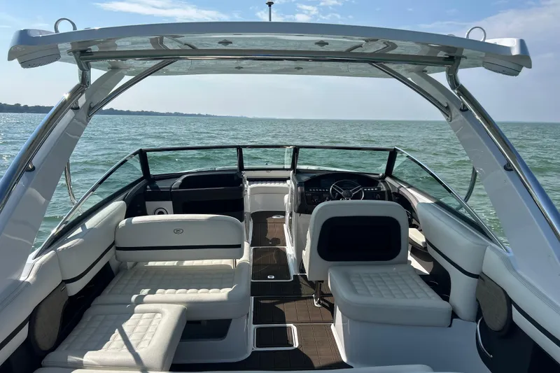  Yacht Photos Pics 2019 Cobalt R30 boat interior with white seating, on a calm lake.