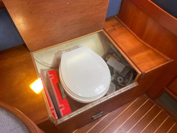 Caribou Yacht Photos Pics Built-in marine toilet on a 2001 Sabre 402 sailboat, with wooden cabinetry.