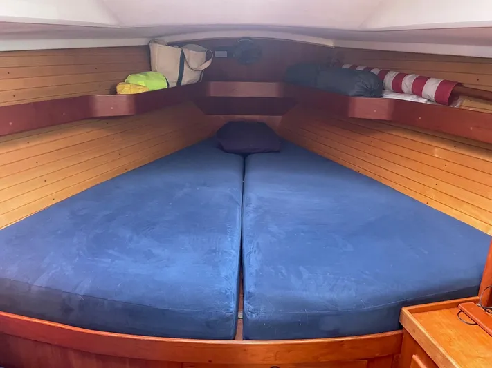 Caribou Yacht Photos Pics Cozy cabin interior of a 2001 Sabre 402 sailboat with blue cushions and wooden paneling.