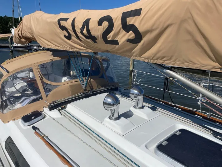 Caribou Yacht Photos Pics 2001 Sabre 402 sailboat with beige sail cover, docked in a marina.