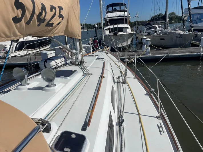 Caribou Yacht Photos Pics Sailboat Sabre 402, 2001 model, docked in a marina with other boats.