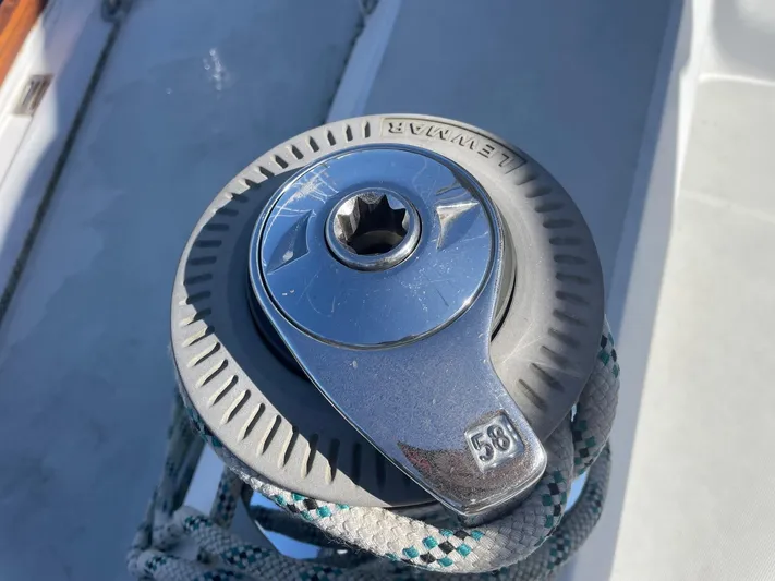 Caribou Yacht Photos Pics Winch on 2001 Sabre 402 sailboat deck with rope and Lewmar branding.