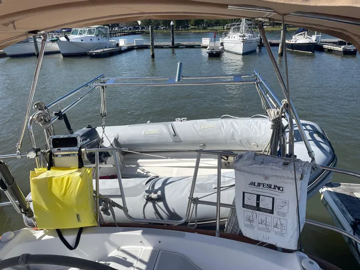 Caribou Yacht Photos Pics Sailboat Sabre 402 (2001) with dinghy and lifesaving equipment at marina.