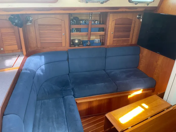 Caribou Yacht Photos Pics Interior of 2001 Sabre 402 yacht with blue cushioned seating and wooden cabinetry.
