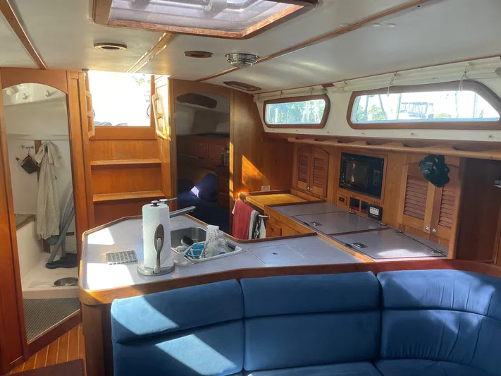 Caribou Yacht Photos Pics Interior of 2001 Sabre 402 sailboat with wooden cabinetry and blue seating.