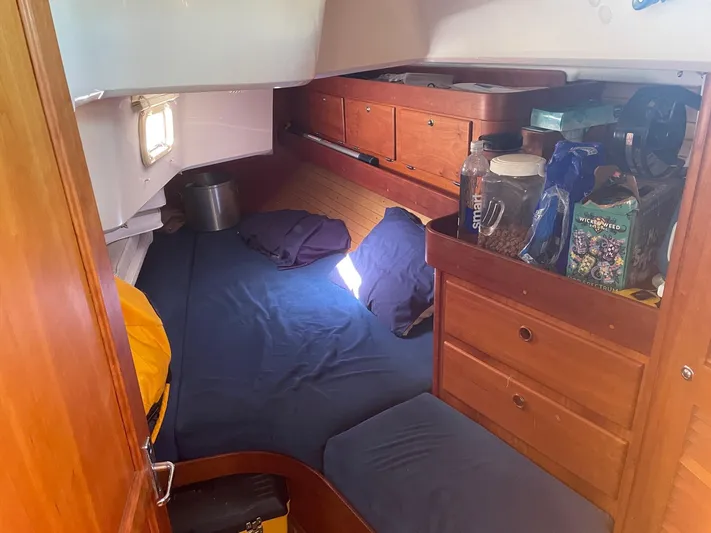 Caribou Yacht Photos Pics Cozy cabin interior of 2001 Sabre 402 sailboat with wooden storage and bedding.