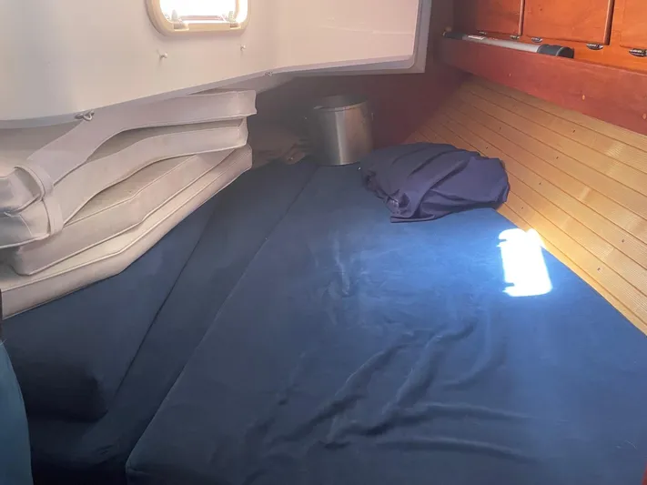 Caribou Yacht Photos Pics Cozy cabin interior of 2001 Sabre 402 sailboat with blue bedding and wooden paneling.