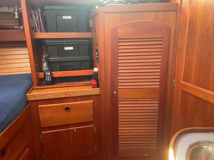 Caribou Yacht Photos Pics Wooden interior of a 2001 Sabre 402 sailboat with storage cabinets and shelves.