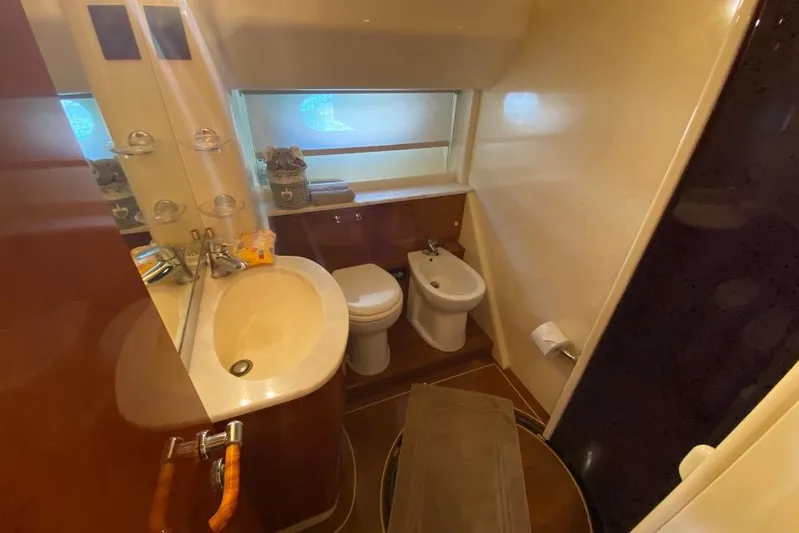 Ukiyo Yacht Photos Pics Luxurious bathroom in 2002 Ferretti Yachts 68, featuring sink, toilet, and bidet.