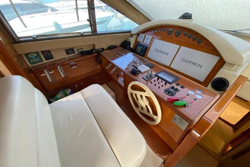 Ukiyo Yacht Photos Pics Helm of 2002 Ferretti Yachts 68 with Garmin navigation systems and wooden dashboard.