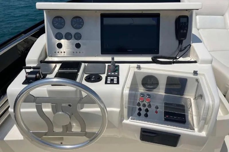 Ukiyo Yacht Photos Pics Cockpit of 2002 Ferretti Yachts 68 with steering wheel and control panel.