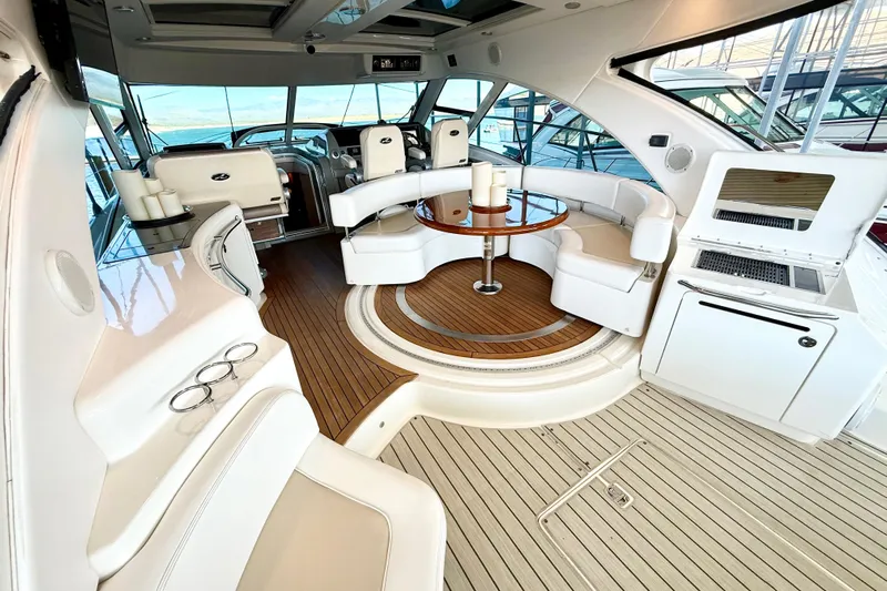 Seas The Day Yacht Photos Pics Luxurious interior of 2014 Sea Ray 580 Sundancer yacht with elegant seating and wood flooring.