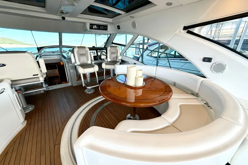 Seas The Day Yacht Photos Pics Luxurious interior of 2014 Sea Ray 580 Sundancer yacht with elegant seating and wooden table.