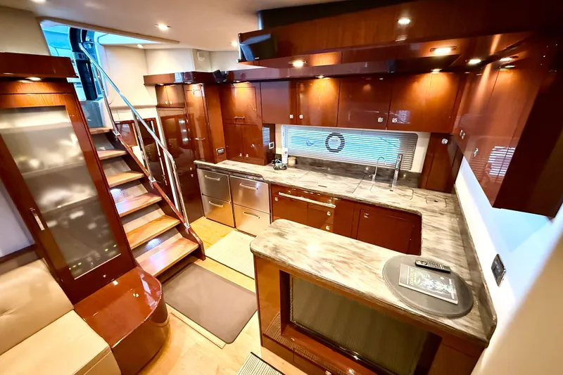 Seas The Day Yacht Photos Pics Luxurious 2014 Sea Ray 580 Sundancer yacht interior with modern kitchen and elegant wood finishes.