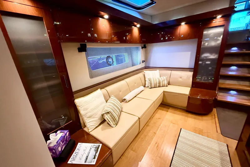 Seas The Day Yacht Photos Pics Luxurious interior of 2014 Sea Ray 580 Sundancer yacht with plush seating and elegant wood finishes.