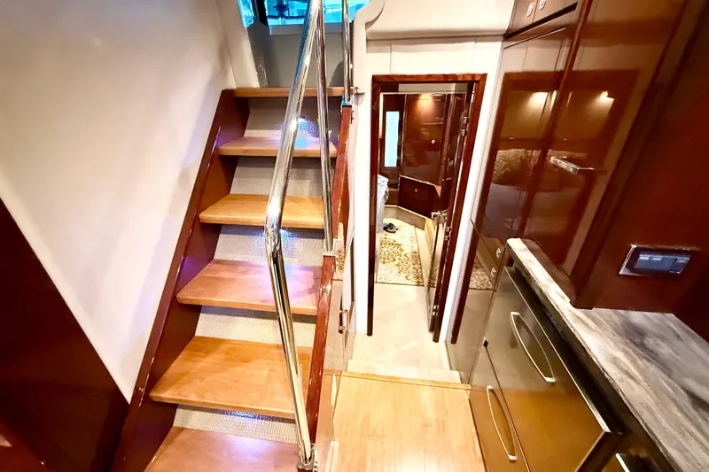 Seas The Day Yacht Photos Pics Interior of 2014 Sea Ray 580 Sundancer yacht with wooden stairs and modern design.