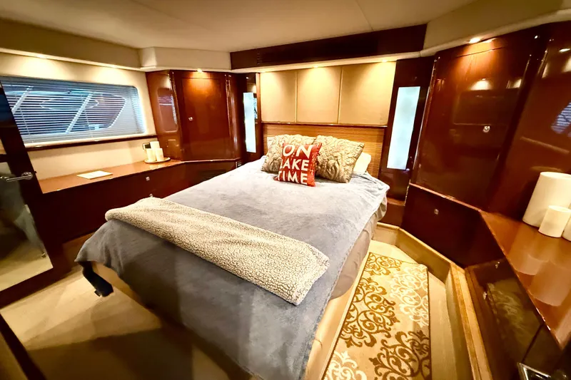 Seas The Day Yacht Photos Pics Luxurious bedroom interior of 2014 Sea Ray 580 Sundancer yacht with elegant wood finishes.
