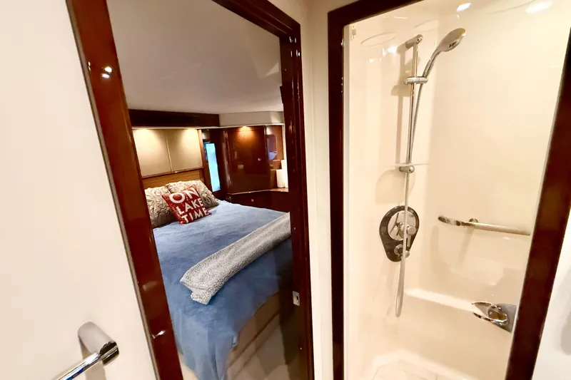 Seas The Day Yacht Photos Pics 2014 Sea Ray 580 Sundancer interior with cozy bedroom and modern shower.
