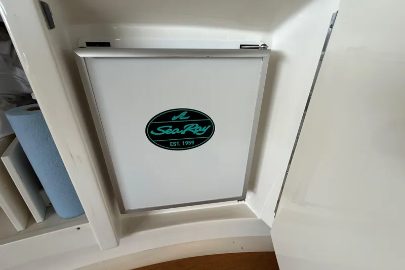 Seas The Day Yacht Photos Pics Sea Ray 580 Sundancer 2014 interior cabinet with logo, featuring sleek design.