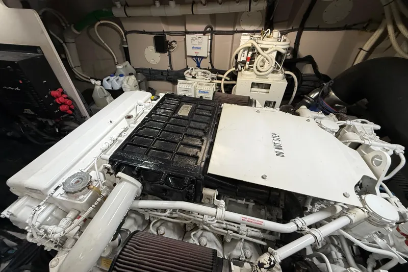 Seas The Day Yacht Photos Pics Engine room of a 2014 Sea Ray 580 Sundancer yacht, showcasing mechanical components.