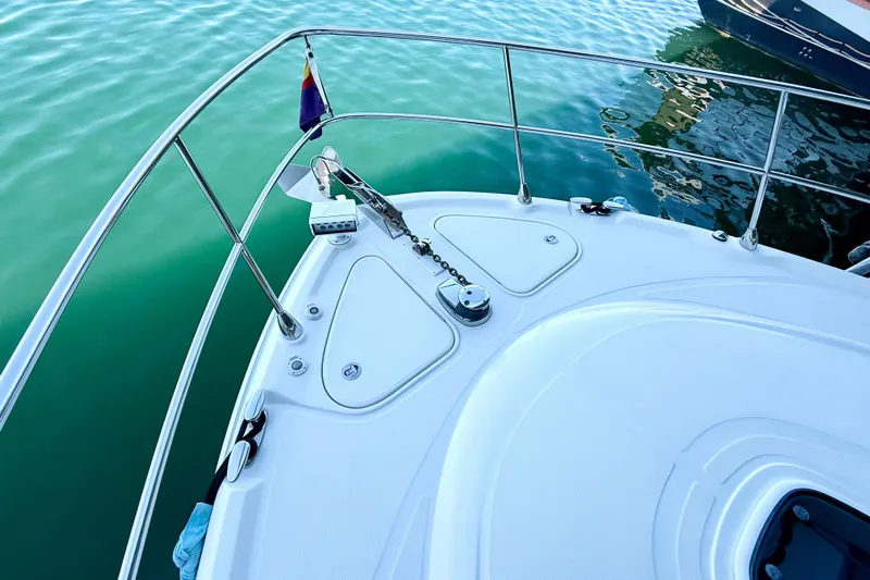 Seas The Day Yacht Photos Pics Bow of 2014 Sea Ray 580 Sundancer yacht on calm water.