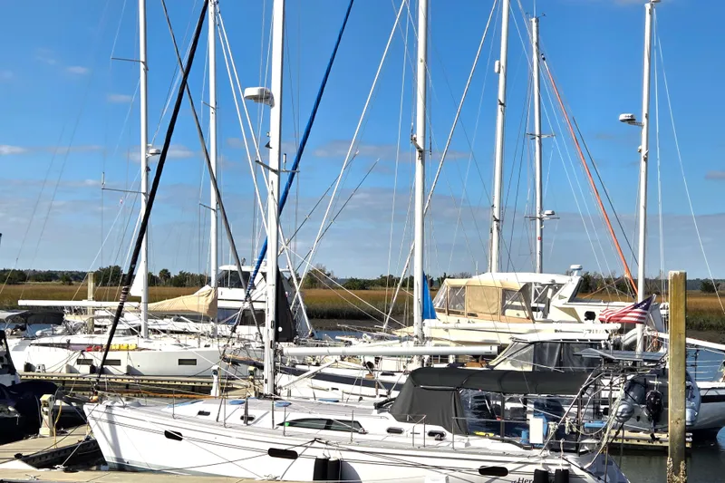 Here & Now Yacht Photos Pics Sailboats docked at marina, featuring a 2021 Catalina 445 under clear blue skies.