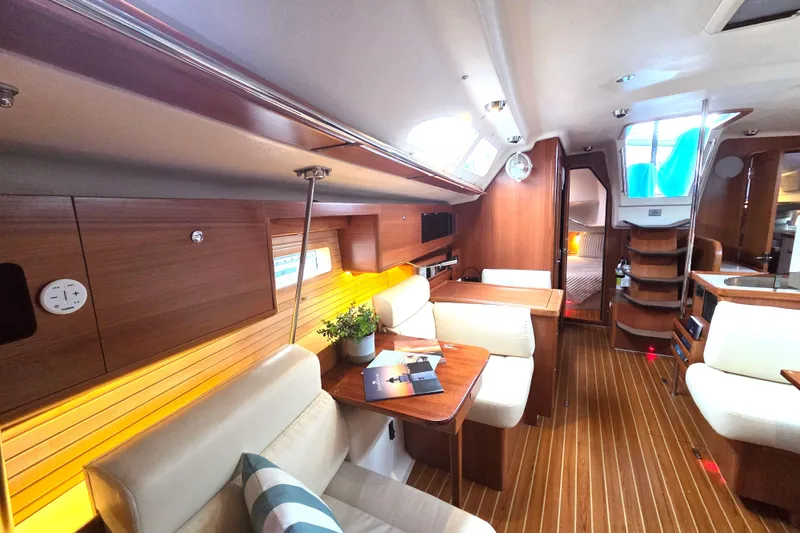 Here & Now Yacht Photos Pics Luxurious interior of 2021 Catalina 445 yacht with elegant wood finish and comfortable seating.