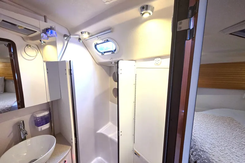 Here & Now Yacht Photos Pics 2021 Catalina 445 yacht interior bathroom with sink, shower, and modern fixtures.