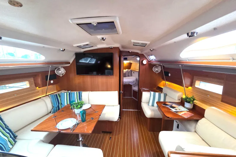 Here & Now Yacht Photos Pics Luxurious 2021 Catalina 445 yacht interior with elegant seating, dining area, and modern amenities.