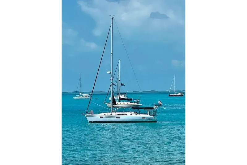 Here & Now Yacht Photos Pics 2021 Catalina 445 sailboat anchored in clear blue waters.