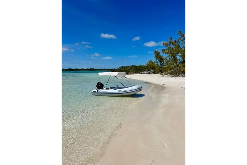 Here & Now Yacht Photos Pics Inflatable boat on a sandy beach with clear water and blue sky, Catalina 445, 2021.