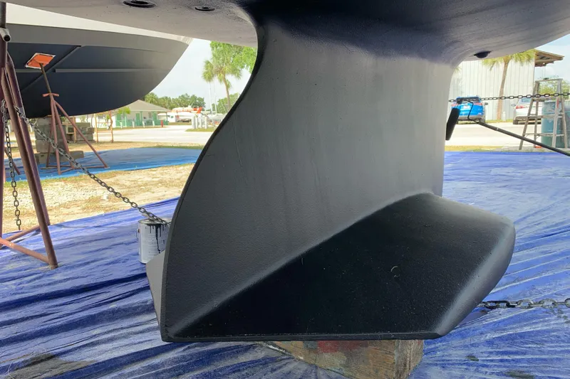 Here & Now Yacht Photos Pics Catalina 445 sailboat keel, 2021 model, on dry dock with blue tarp.